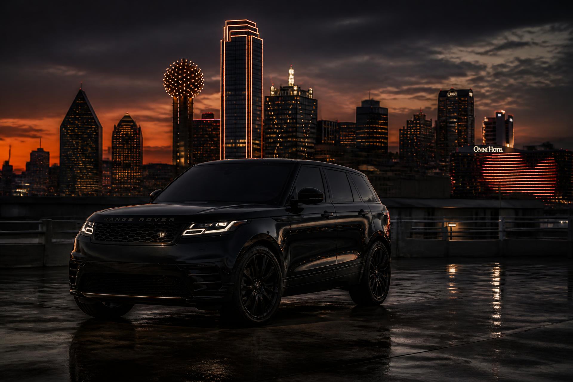 Mike beside a black SUV with the Dallas skyline at dusk